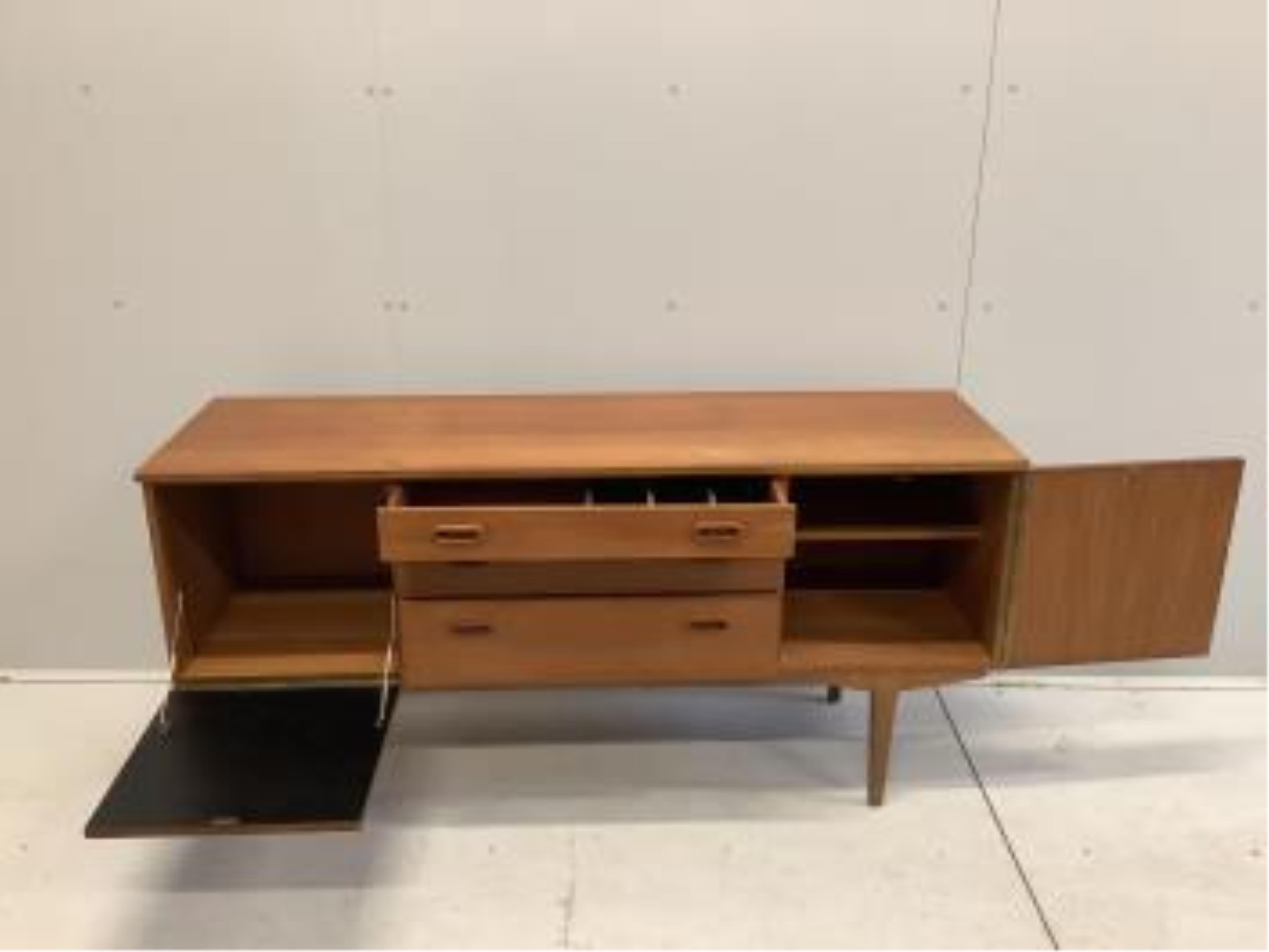 A mid century teak sideboard, probably Nathan Furniture, width 153cm, depth 44cm, height 72cm. Condition - fair